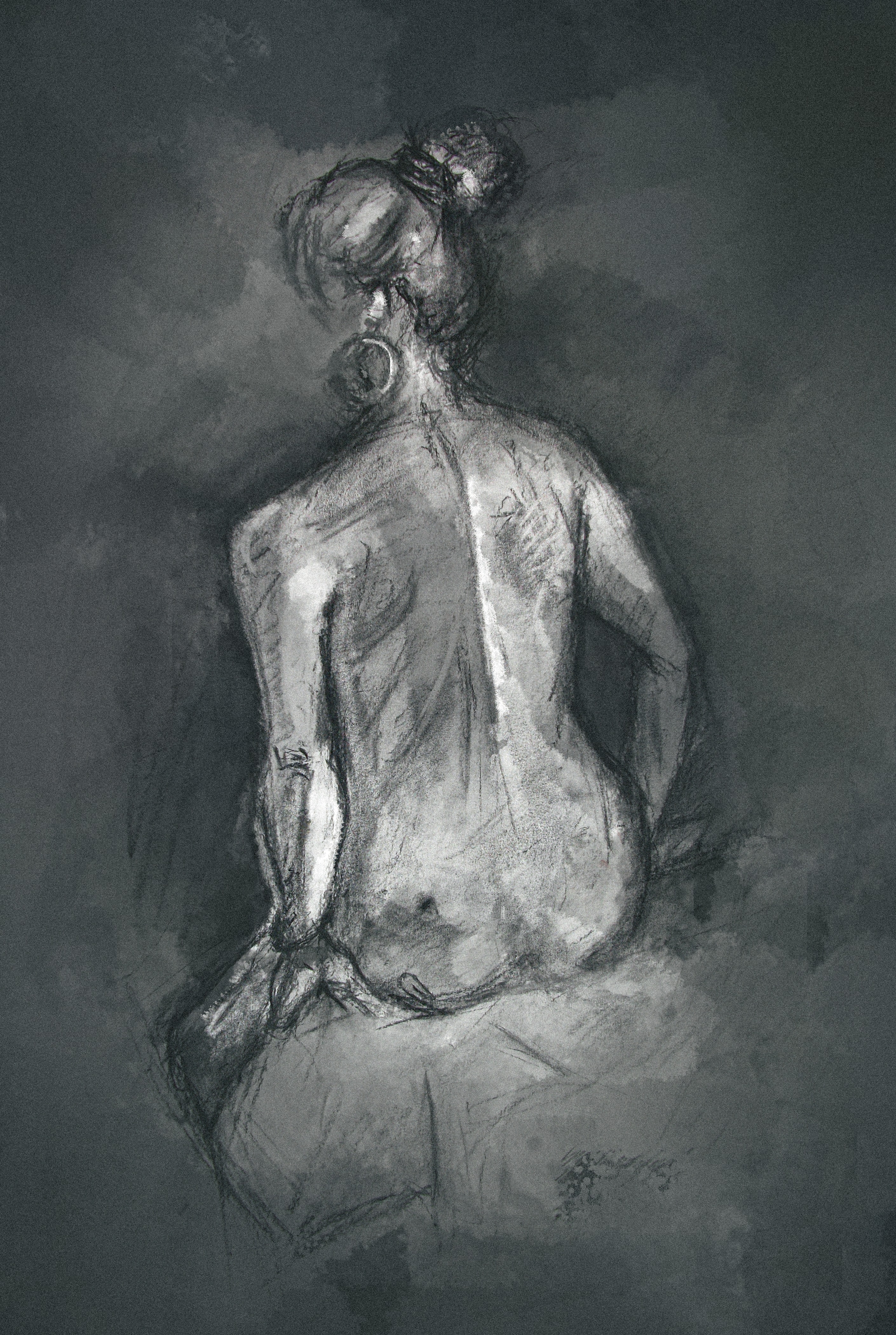 Charcoal study showing a woman enveloped in darkness with light shining